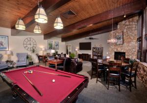 a billiard room with a pool table and a bar at Falcon Point in Avon