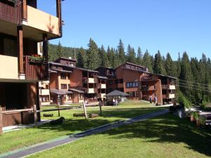 a group of buildings with trees in the background at Multiproprietà Rio Falzè in Madonna di Campiglio