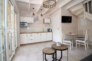 a kitchen with a table and two chairs and a dining room at Baltic Sky in Pobierowo