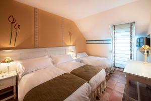 Postel nebo postele na pokoji v ubytování Hotel La Posada De Alameda