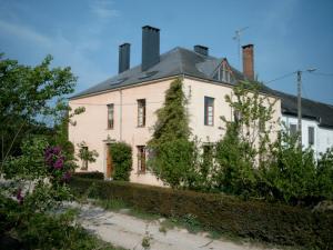 an old white house with a gray roof at Le Thirifays in Chiny