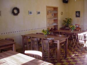 a dining room with wooden tables and chairs at Le Thirifays in Chiny