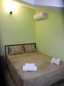 a bedroom with a bed with towels on it at Cherdachok in Tbilisi City