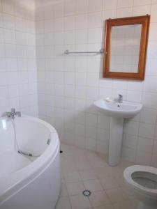 a bathroom with a tub and a sink and a toilet at Apartments Beti in Ulcinj