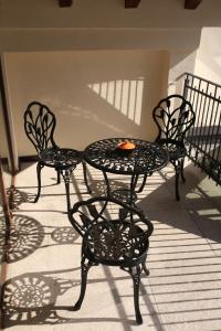 two chairs and a table on a patio at Artisans Boutique Villa in Sibiu