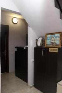 a room with two black cabinets and a painting on the wall at Hotel Peria in Batumi