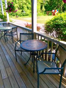 a table and chairs sitting on a deck at Lyn Aire Motel - Lake George in Lake George