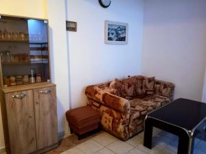 a living room with a couch and a table at Guestrooms Stoyanovi in Chernomorets
