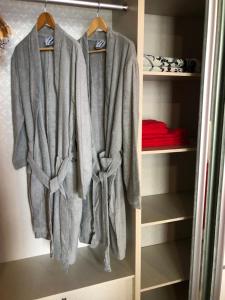 a closet with gray clothes hanging on a rack at Atlantis Residence in Melaka