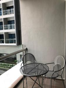 two chairs and a table on a balcony at Atlantis Residence in Melaka