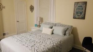 a bedroom with a white bed with two pillows at Relaxing, Comfortable, Private Bedroom in Atlanta