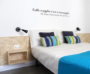 A bed or beds in a room at Le Mangiatoie del Cavaliere