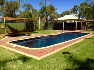 a swimming pool in a yard with a house at Comfort Suites Clubarham Golf Resort in Barham