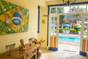 a living room with a door leading to a pool at Pousada Berço da Liberdade in Tiradentes
