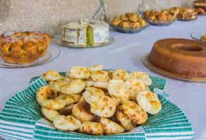 a table topped with a cake and a plate of food at Pousada Berço da Liberdade in Tiradentes +111 photos