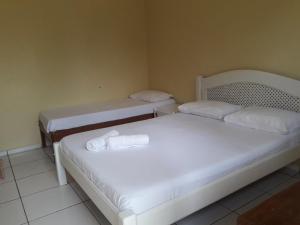 Tempat tidur dalam kamar di Pousada Santa Bárbara