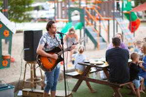 a man playing a guitar at a microphone at Ingenia Holidays Rivershore in Maroochydore +47 photos