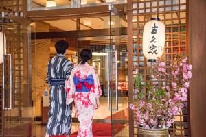 a man and a woman walking through a lobby at Kokuya in Shibukawa +142 photos