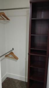 a closet with wooden shelves in a room at Cattlemen Motel in Lovell