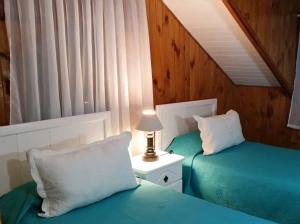 Postel nebo postele na pokoji v ubytování Hotel y Cabañas Molino Viejo
