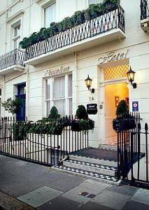 a building with a gate in front of a store at Piccolino Hyde Park Hotel in London
