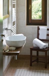 a bathroom with a white sink on a wooden table at Brusco rooms in Como