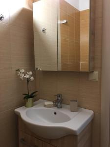 a bathroom with a white sink and a mirror at Athinaios Porto Klisouri Villa in Ierissos +55 photos