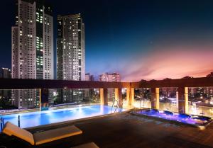 a pool on the roof of a building at night at Park Marine Hotel in Incheon