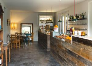 a restaurant with a counter and a dining room at Brusco rooms in Como