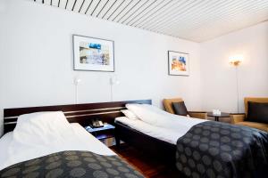 Katil atau katil-katil dalam bilik di Havly Hotell