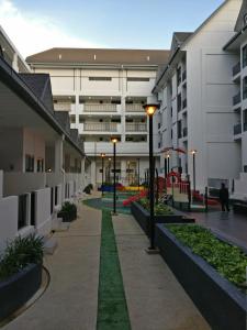 a courtyard of an apartment building with a playground at SL TR Homstay in Cameron Highlands