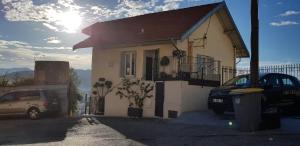a house with a car parked in front of it at Maison / Appart Le PIOL in Nice