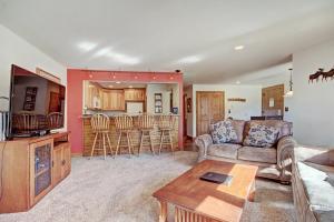 a living room with a couch and a table at Ffd7 Frostfire Condo in Keystone