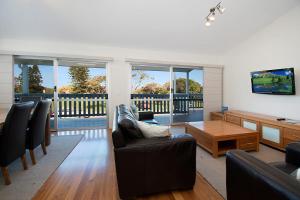 a living room with a couch and a table at Seascape - Lennox Head in Lennox Head