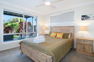 a bedroom with a bed and a large window at Seascape - Lennox Head in Lennox Head