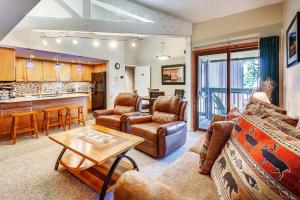 a living room with a couch and a table at 1088 Wild Irishman Condo in Keystone