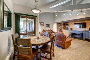 a dining room and living room with a table and chairs at 1088 Wild Irishman Condo in Keystone