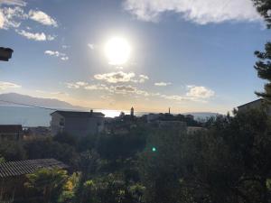 a view of the sun setting over a city at Villa Blatina in Gradac