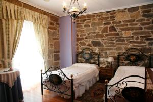 A bed or beds in a room at Hotel Pousada Vicente Risco