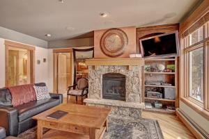 a living room with a couch and a fireplace at 3044 Lone Eagle Condo in Keystone