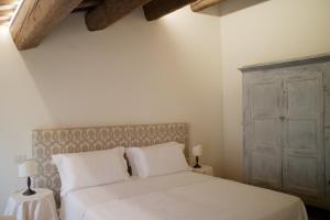 a bedroom with a bed with white sheets and pillows at Le Case Di San Vitale Easy in Ravenna +14 photos