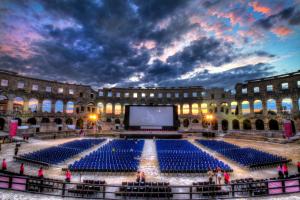 a large amphitheatre with a large screen in front of a building at Apartments Antons 2 in Pula