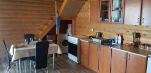 a kitchen with a table and a sink and a stove at Holiday House Kruce in Ulcinj