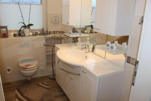 a bathroom with a sink and a toilet at Befeld Susanne in Neustadt in Holstein +51 photos