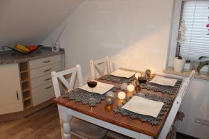a dining room table with two glasses of wine on it at Befeld Susanne in Neustadt in Holstein