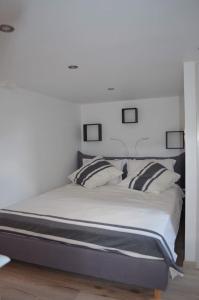 a bedroom with a large bed with two pillows at Le Pigeonnier de Château Picon in Eynesse