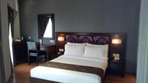 Postel nebo postele na pokoji v ubytování Castello Hotel