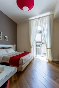 a bedroom with a bed and a large window at NovaNova in Naples