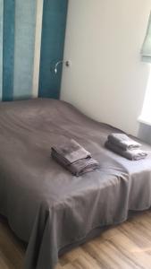 a bed with two towels on it in a room at Mieszkanie Świdnik in Świdnik