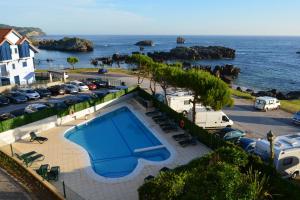 a swimming pool with a view of the ocean at Hotel Torre Cristina in Noja